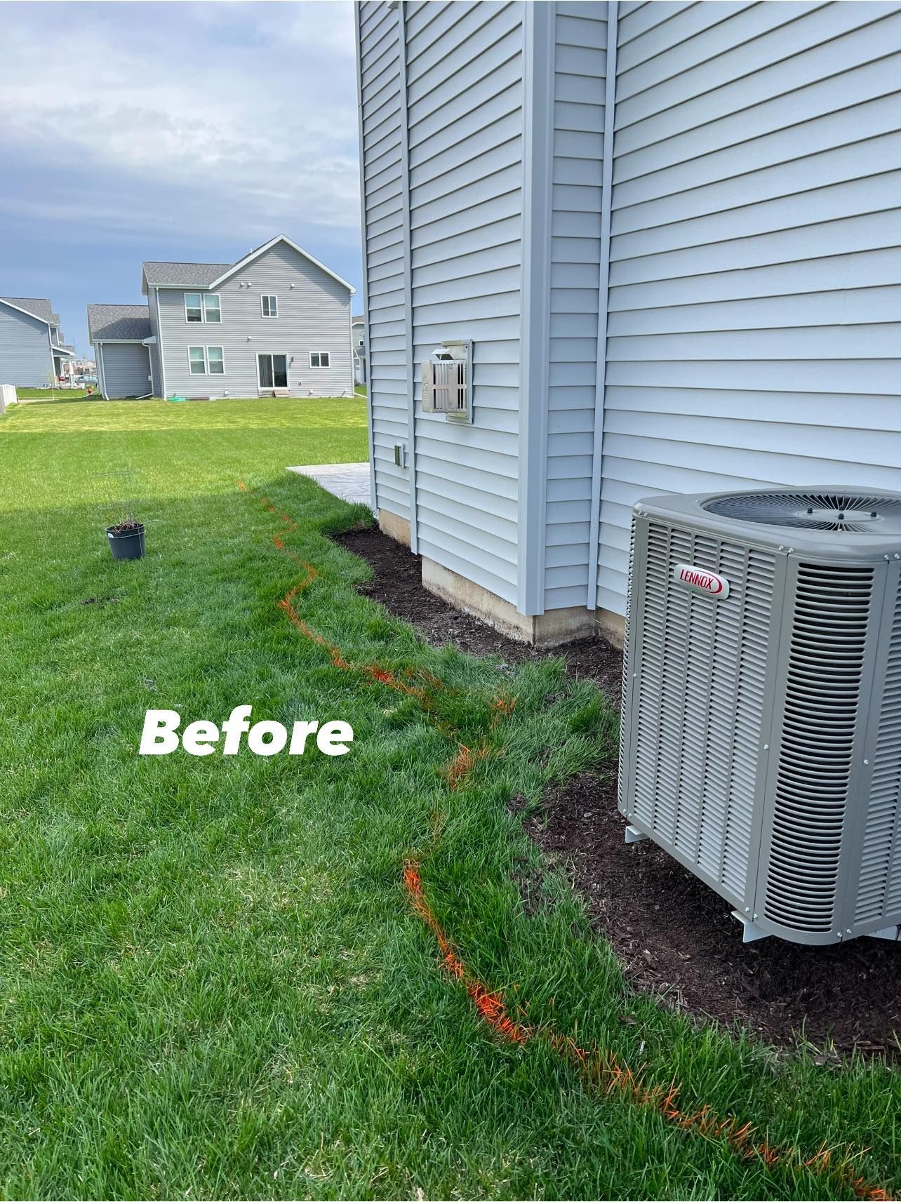 A picture of a house with a air conditioner on the side of it.