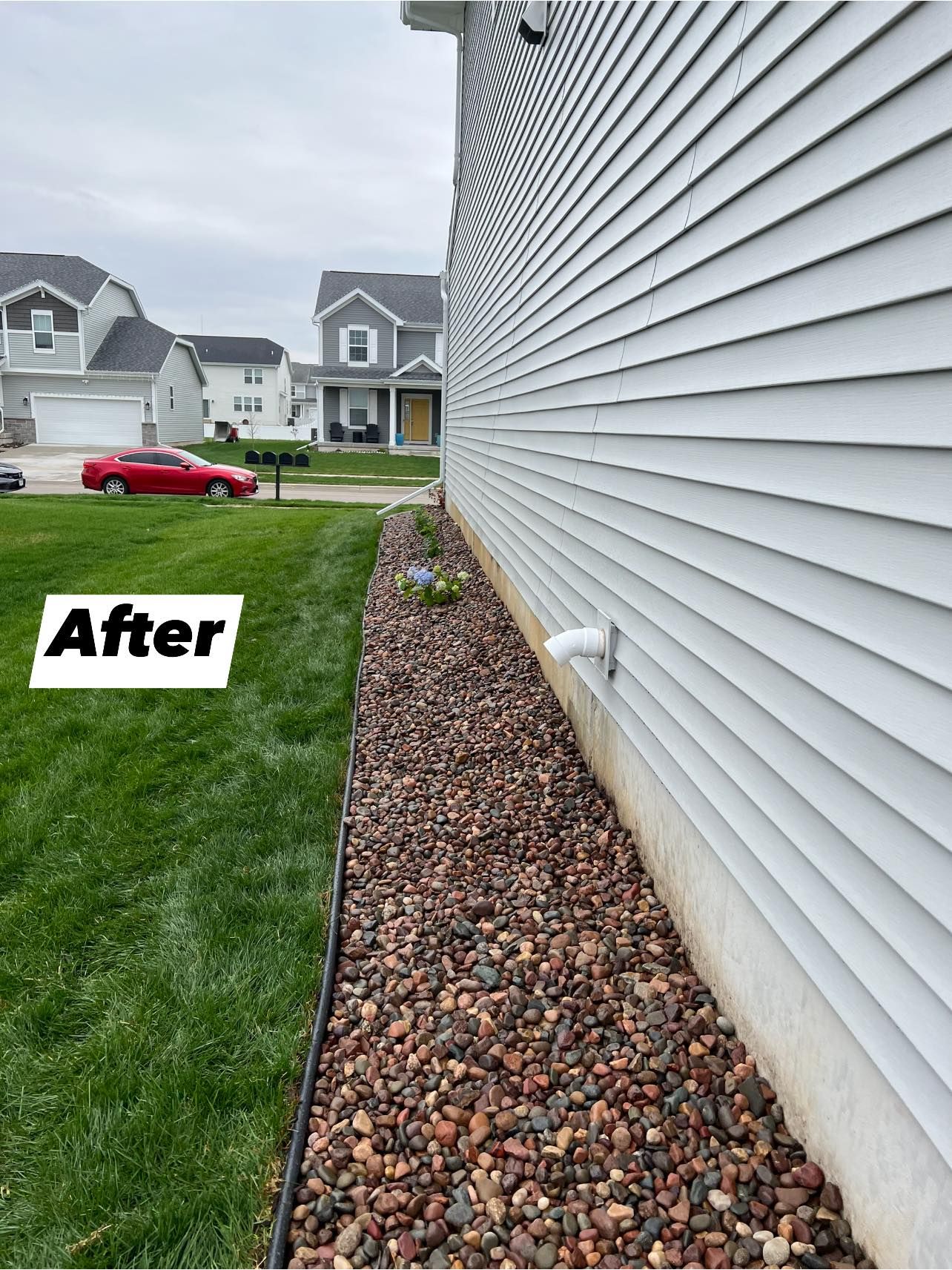 A picture of a house after being cleaned and landscaped.