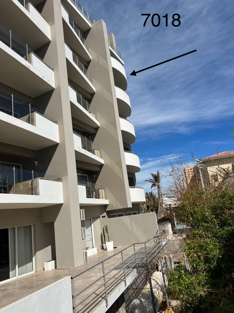 A building with a arrow pointing to the number 7018