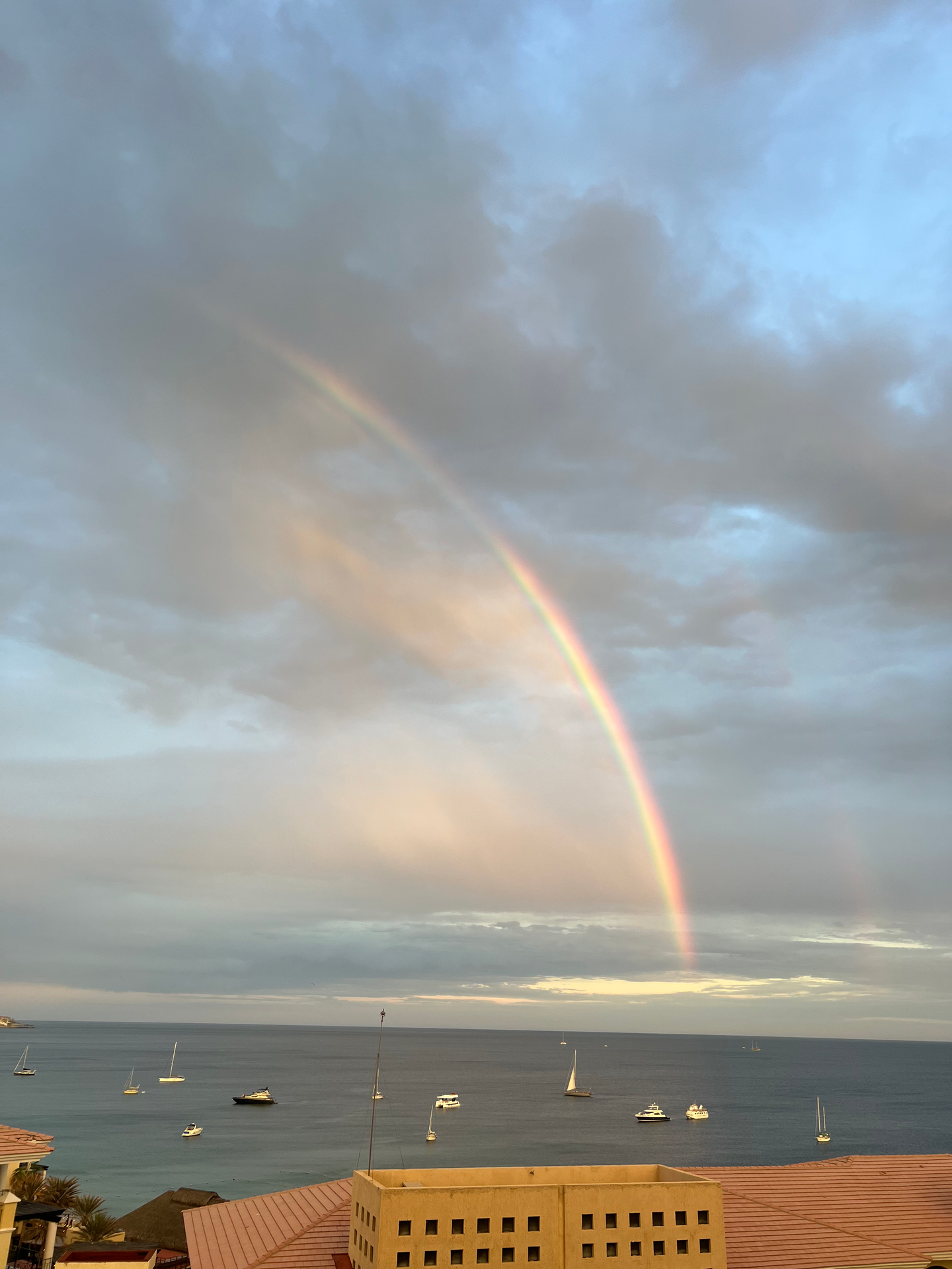 A rainbow is visible over a body of water