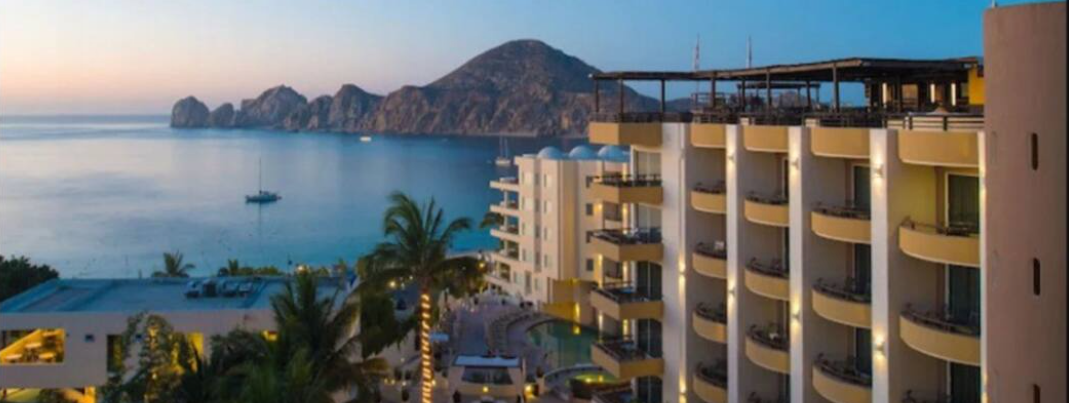 An aerial view of a hotel with a view of the ocean.
