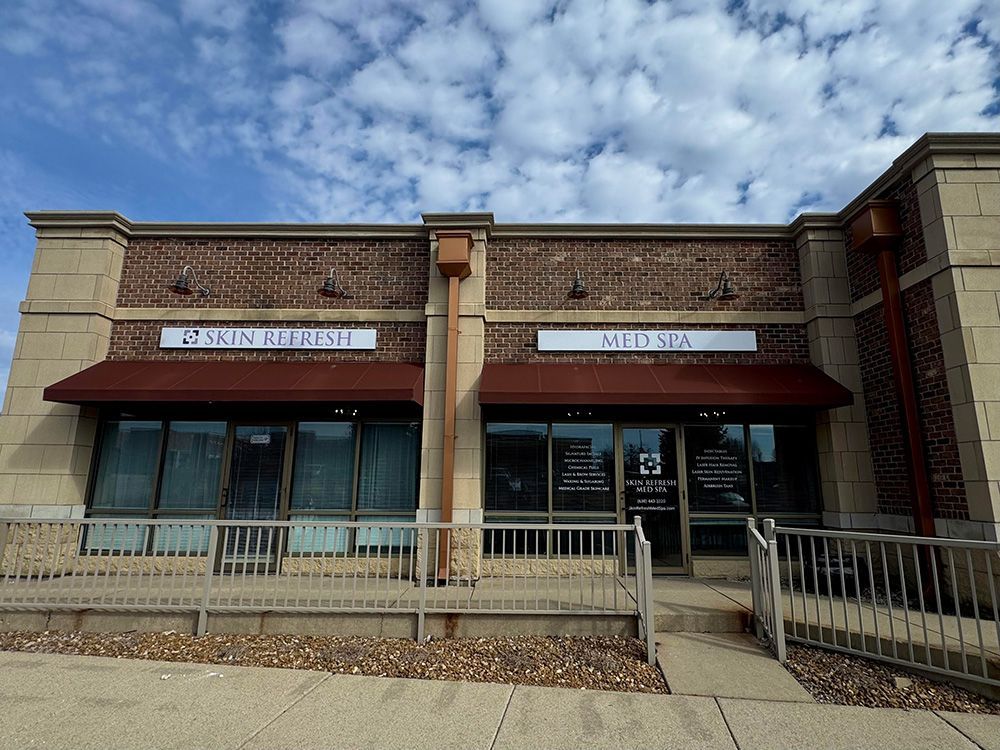 A brick building with a purple awning that says miller