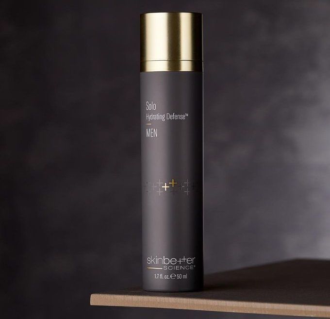 A black bottle with a gold cap that says sisley on it
