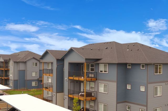 A large apartment building with a carport in front of it