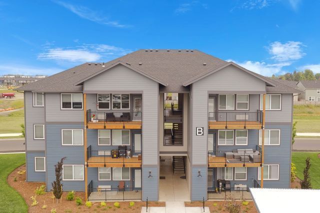 An aerial view of a large apartment building with balconies.