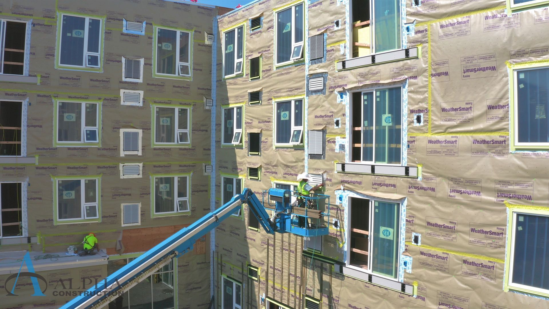 A large building with a lot of windows is being built.