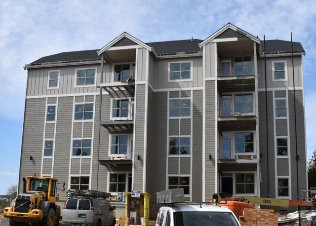 A large building with a lot of windows is being built