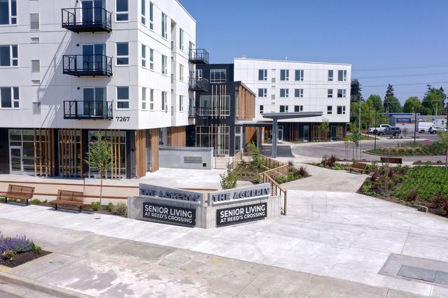 A large white building with a sign that says senior living