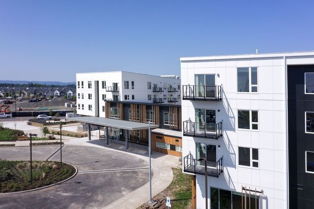 A large apartment building with a lot of windows and balconies