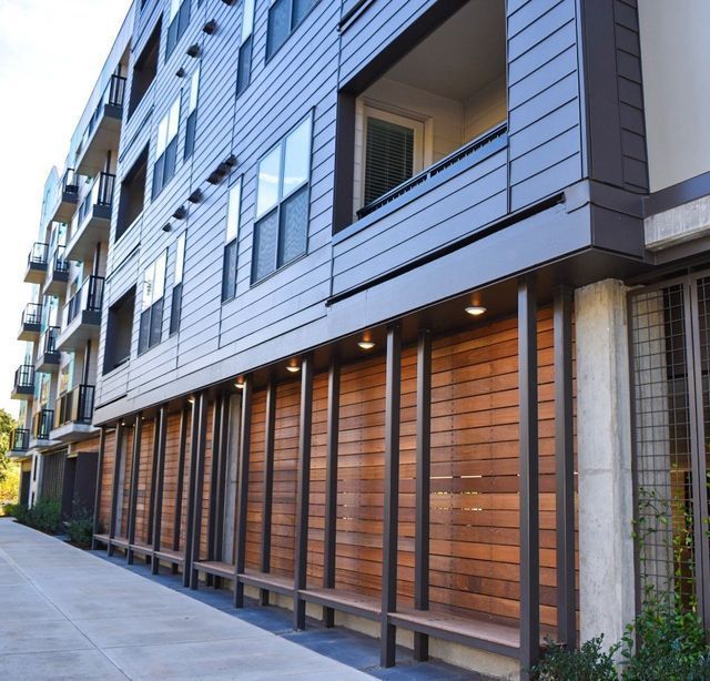 A building with a lot of windows and a wooden facade