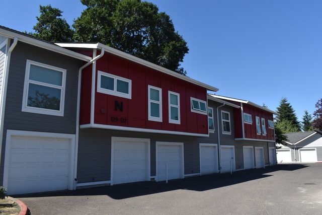 A red and gray building with white garage doors