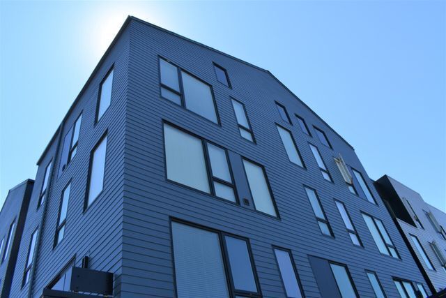 A building with a lot of windows and a blue sky in the background