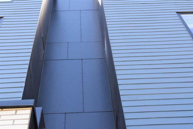 A close up of a building with a gray roof