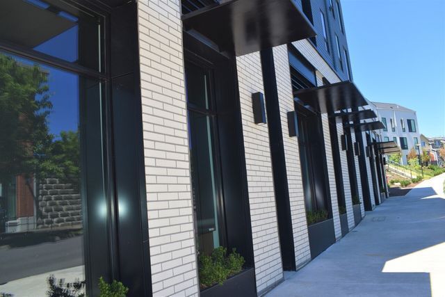 A building with white bricks and black trim