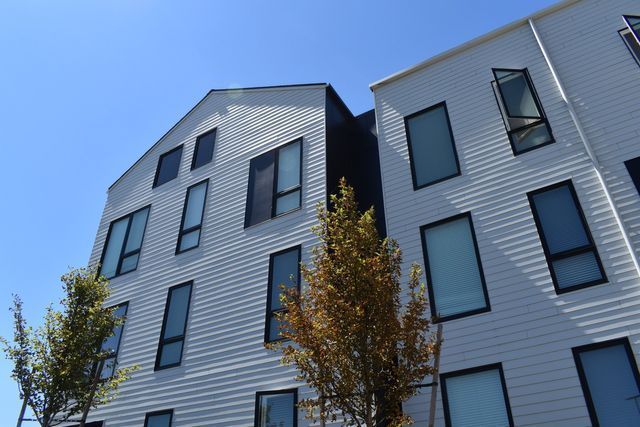 A building with a lot of windows and trees in front of it