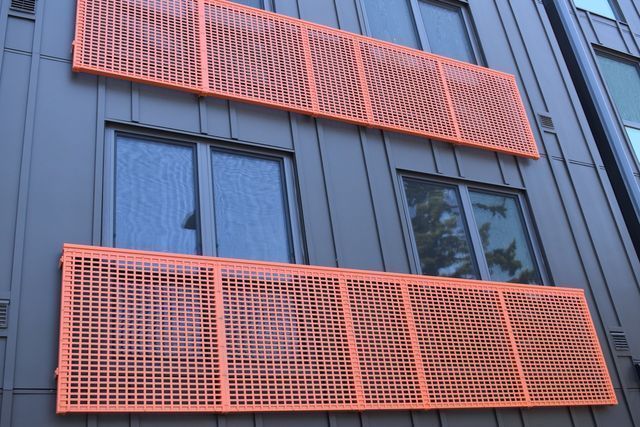 A building with orange balconies on the side of it