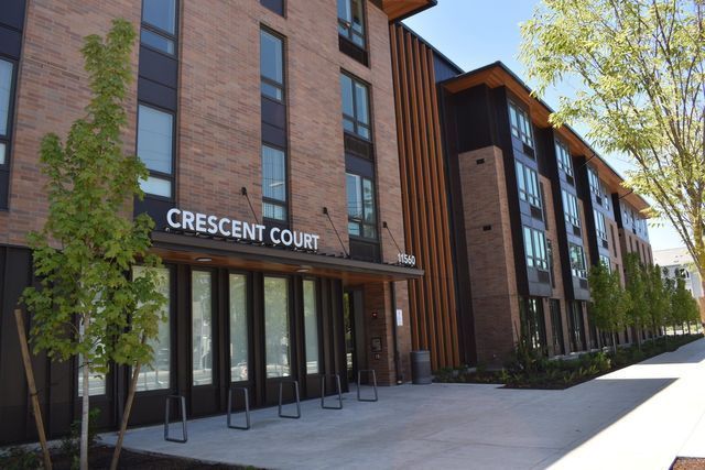 A large brick building with a sign that says crescent court