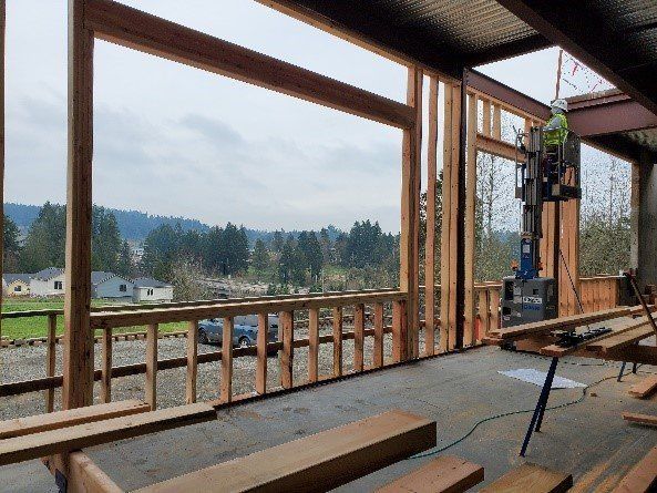 A building is being built with wooden beams and a large window.