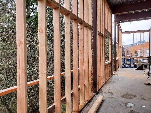 A wooden wall is being built in a building under construction.