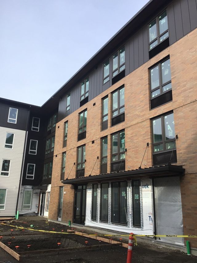 A large building with a lot of windows is under construction.