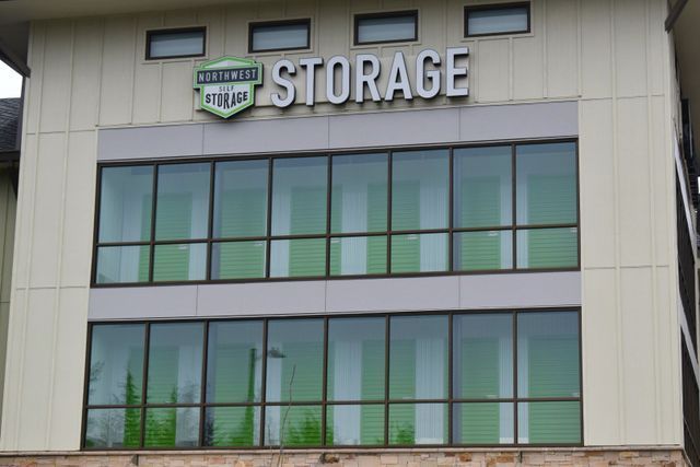 A large building with lots of windows and a sign that says storage