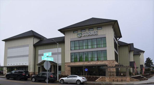A large storage building with cars parked in front of it