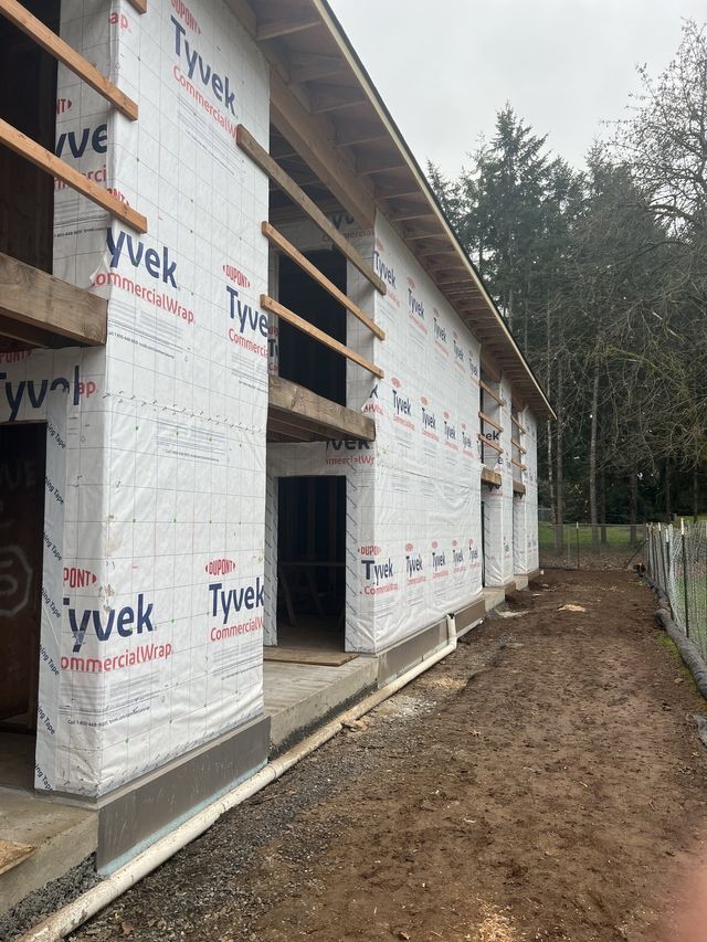 A building is being built with tyvek insulation on the walls.