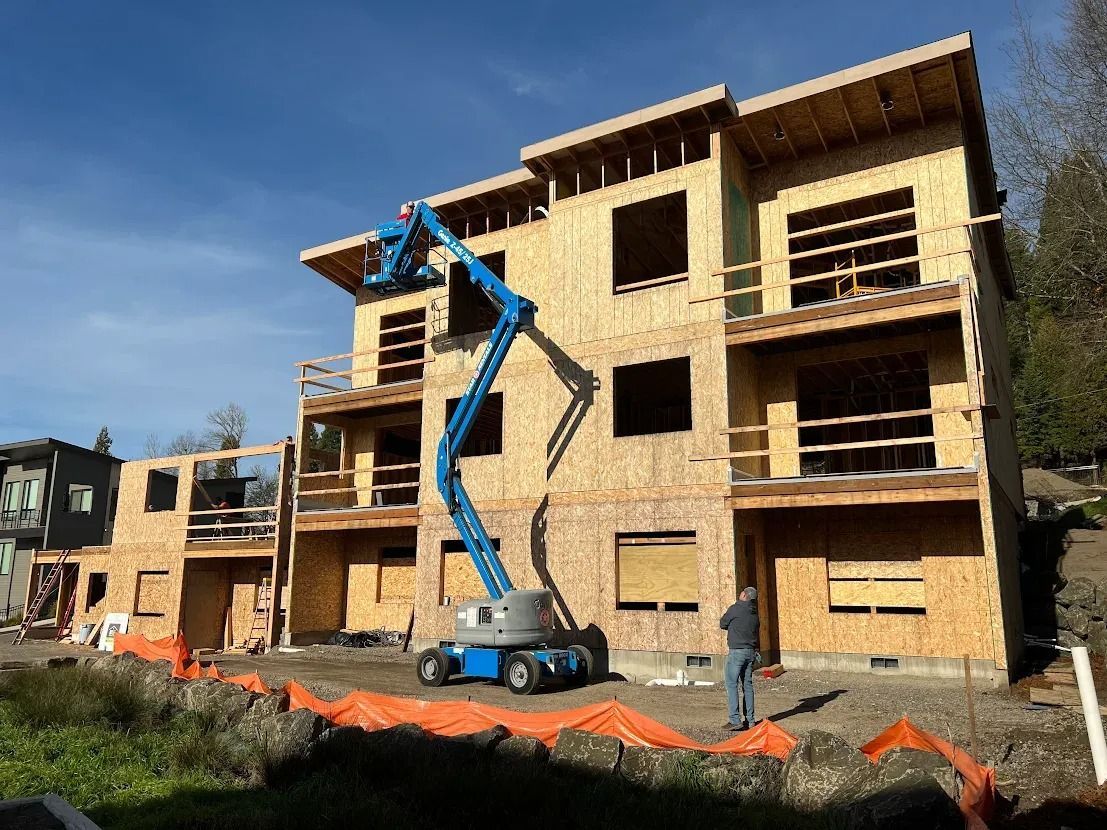 A large building is being built with a crane in front of it.