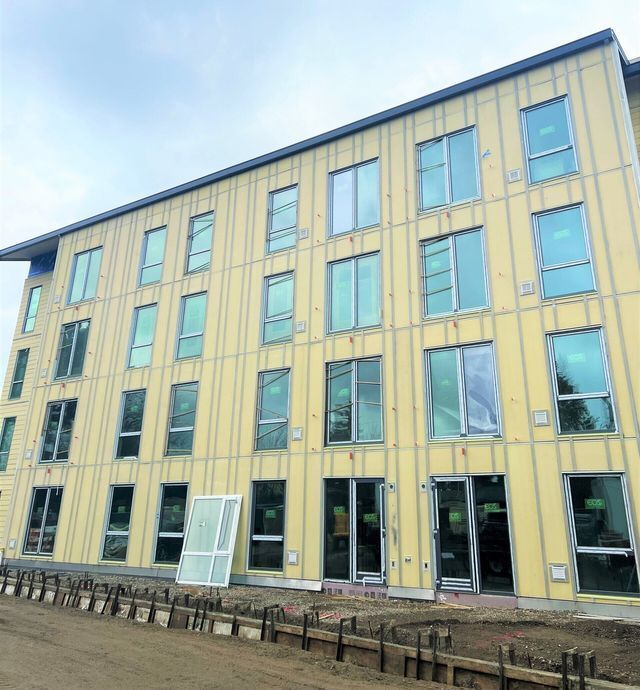 A large yellow building with a lot of windows and doors