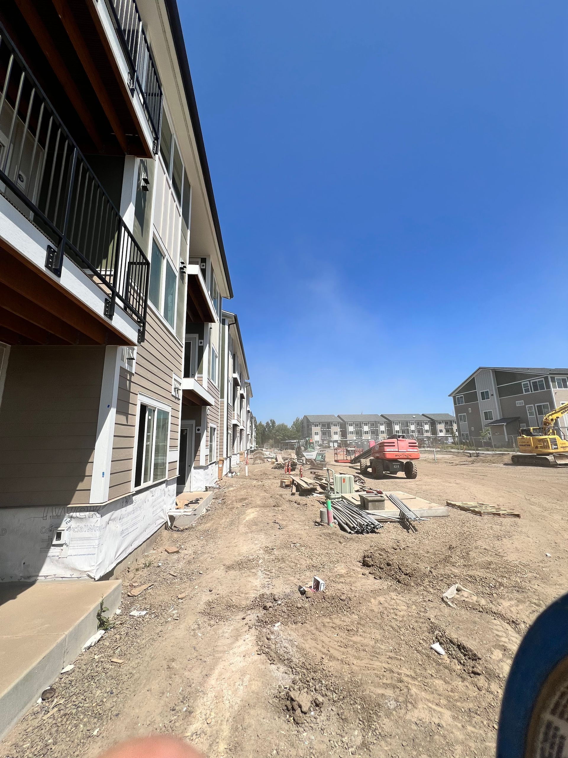 A building under construction with a lot of dirt in front of it.