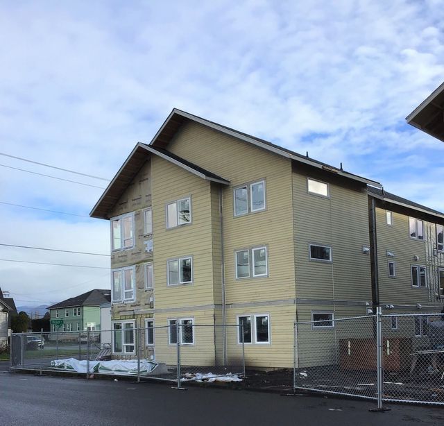 A large yellow building with a fence around it