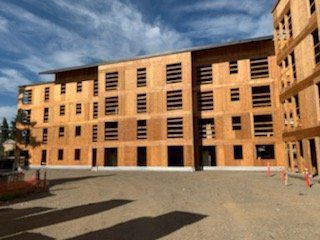 A large wooden building under construction with a lot of windows