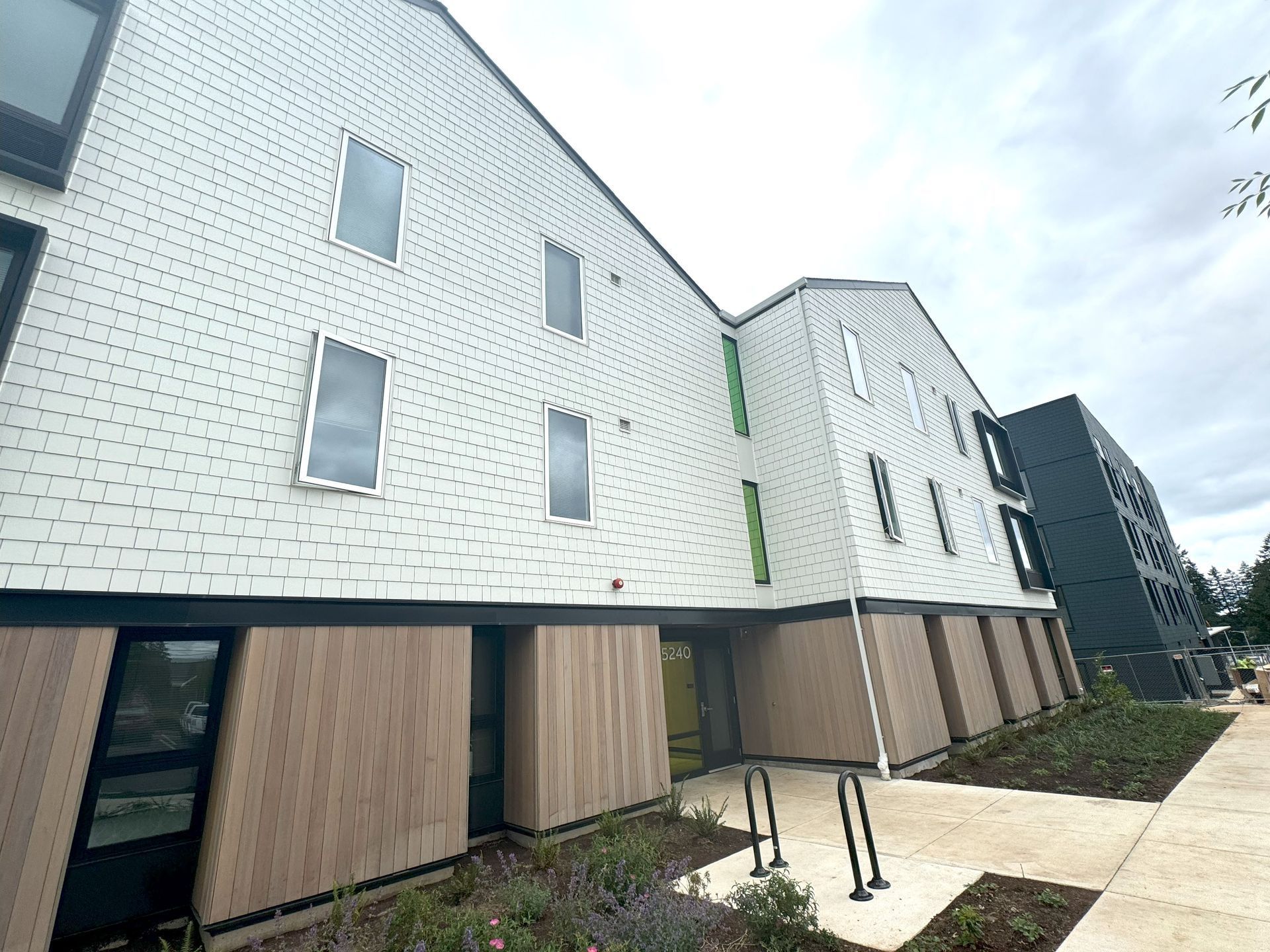 A large white brick building with a lot of windows and doors.