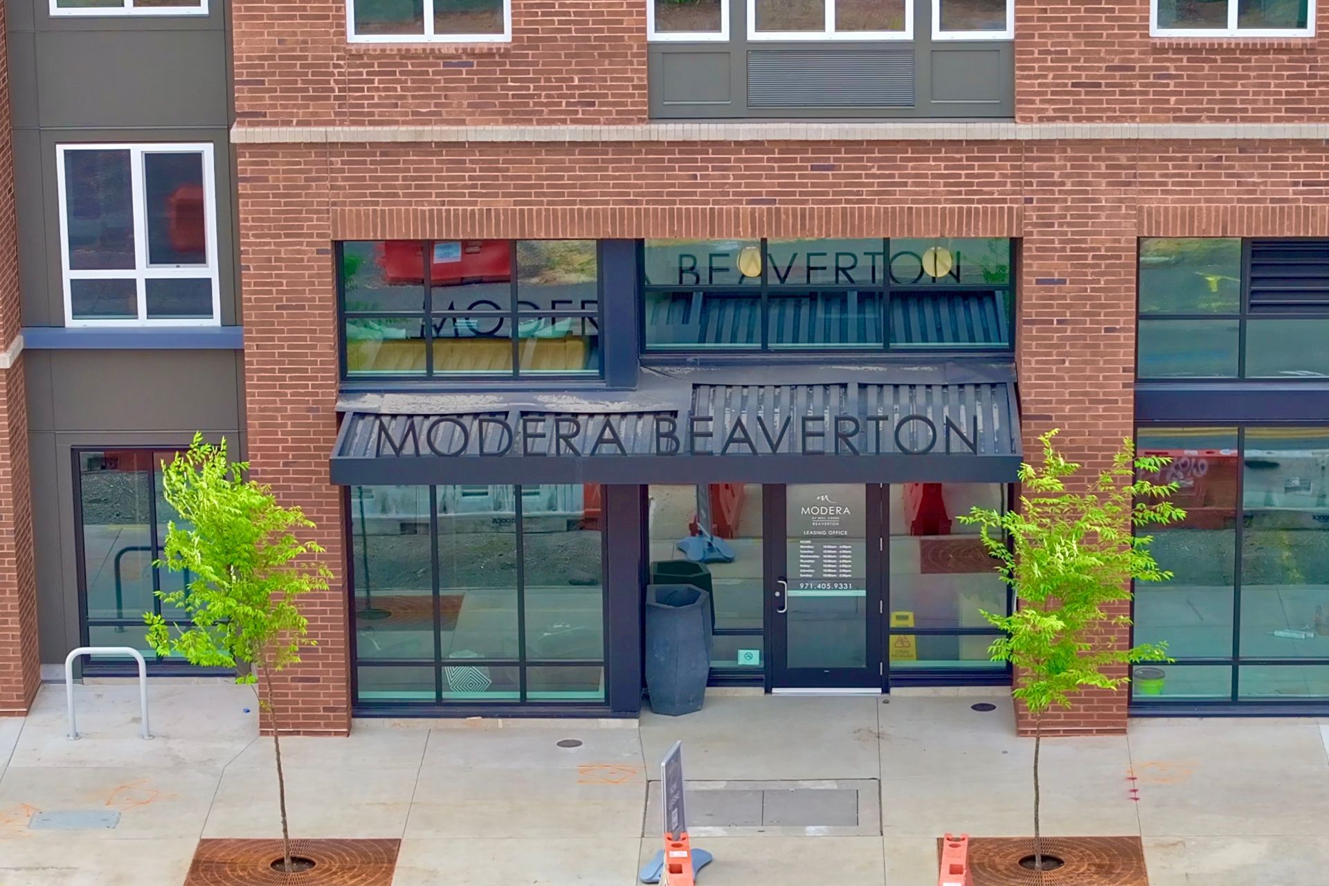 A large brick building with a sign that says arts plaza apartment