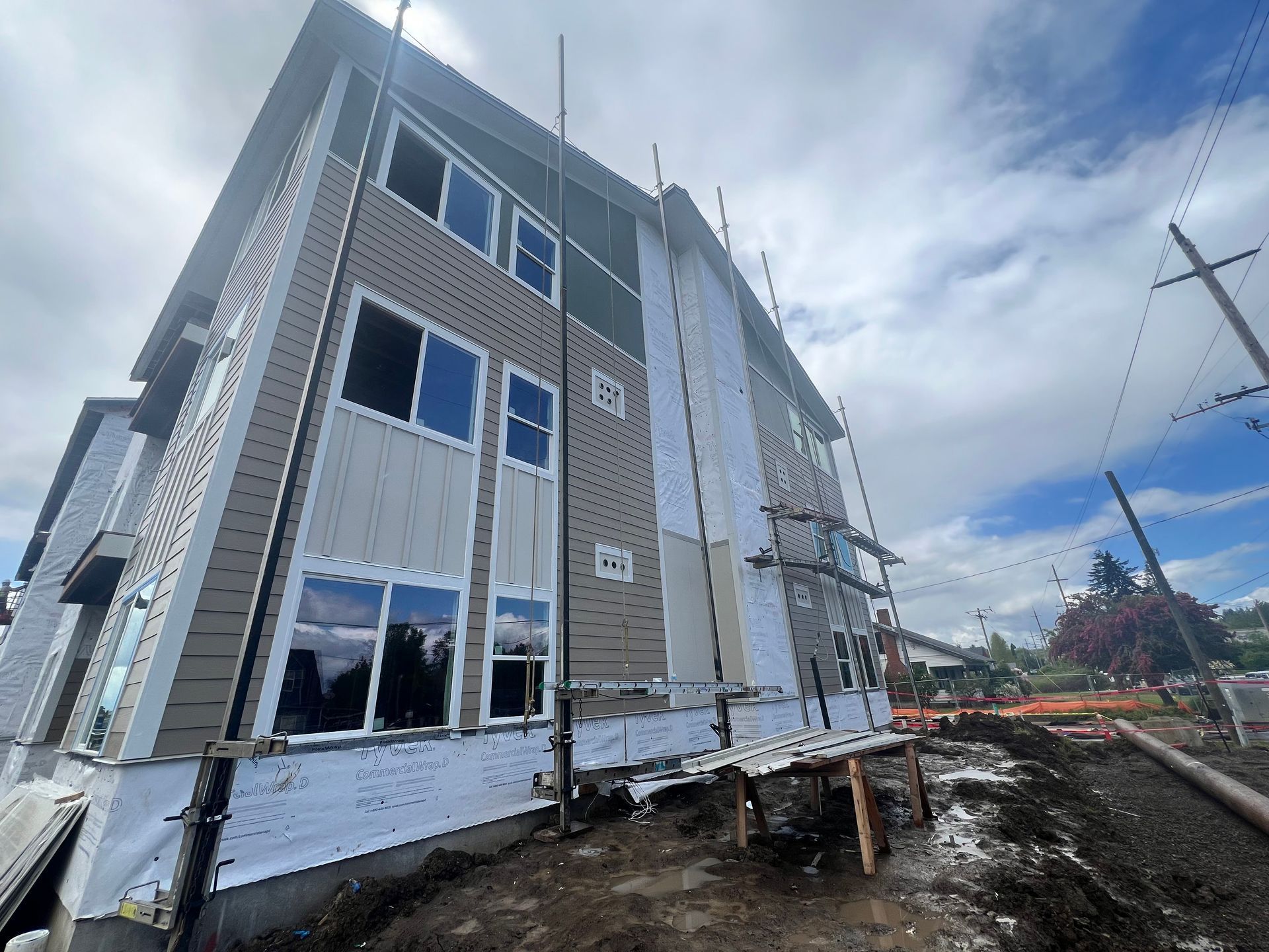 A large building with a lot of windows is under construction.