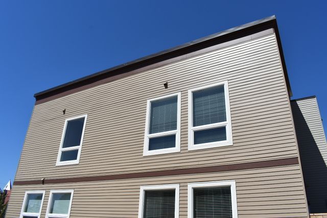A house with a lot of windows and a blue sky in the background