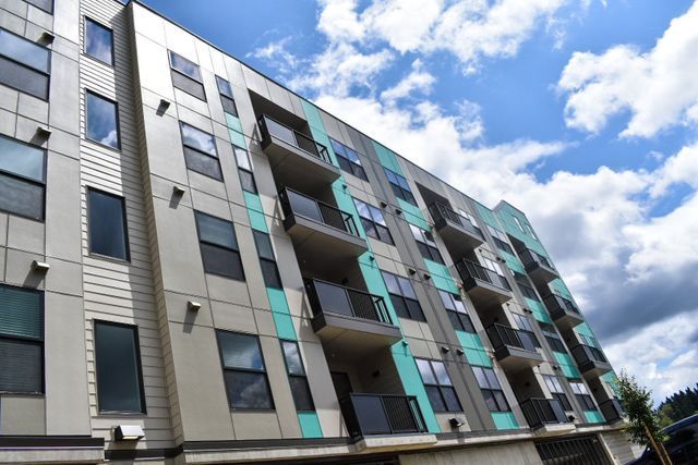 A large apartment building with a lot of windows and balconies.
