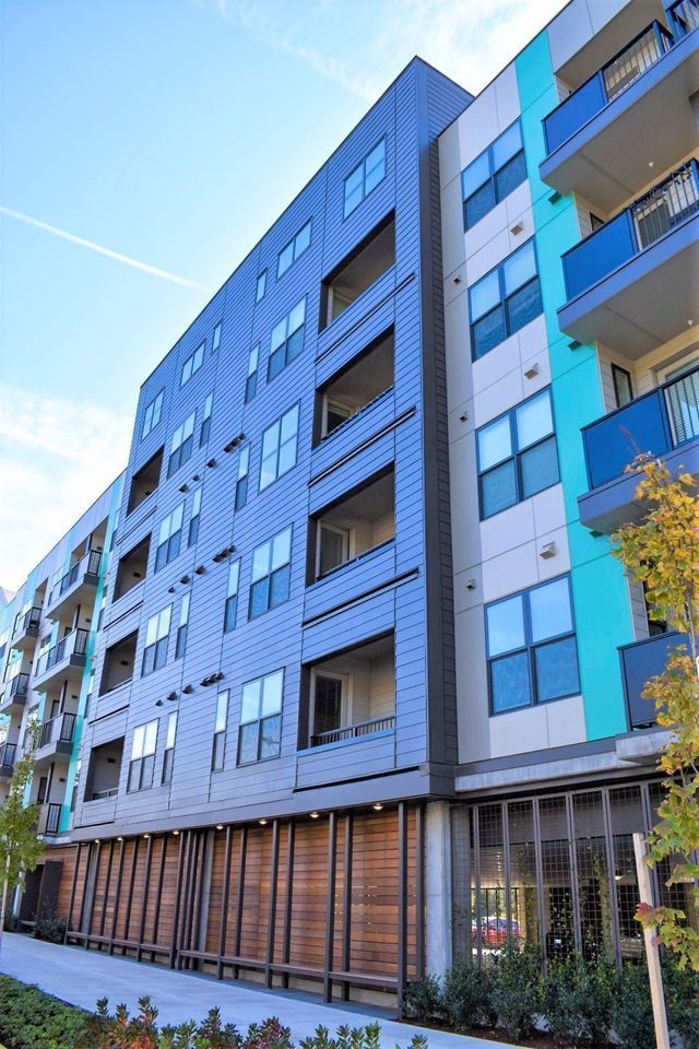 A large apartment building with a lot of windows and balconies
