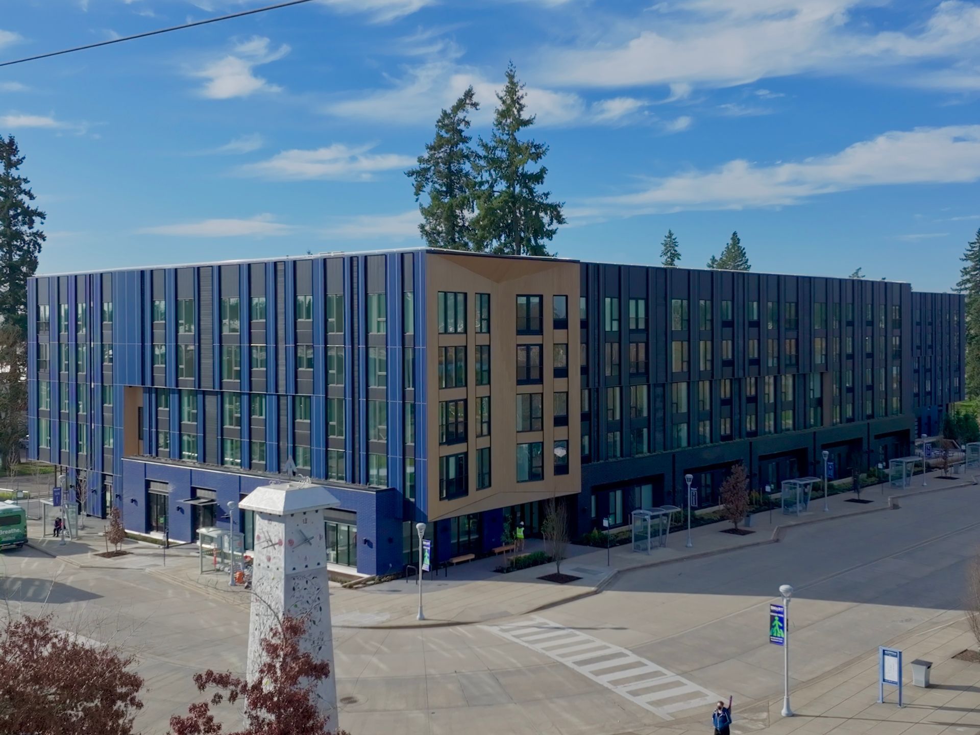 A large brick building with a sign that says arts plaza apartment