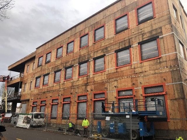 A large building with a lot of windows is being built.