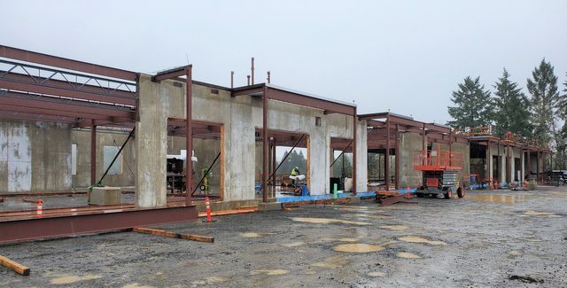 A row of buildings under construction on a cloudy day.
