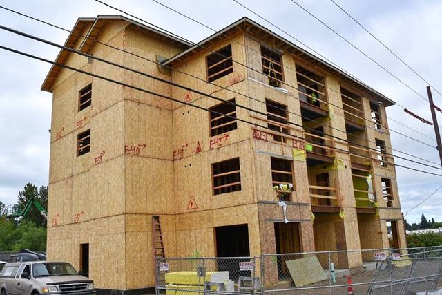 A building under construction with a fence around it