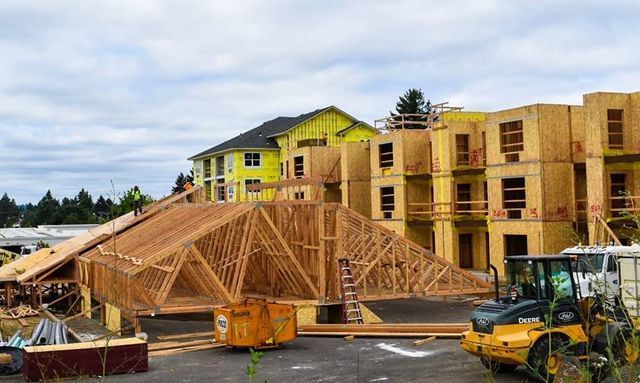 A large building is being built with a lot of wood.