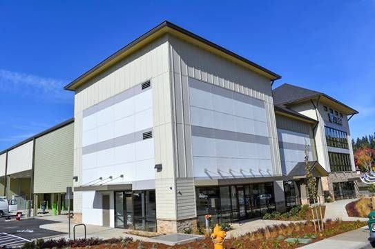 A large white building with a fire hydrant in front of it.