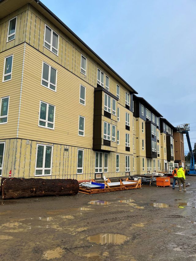 A large building with a lot of windows is being built.