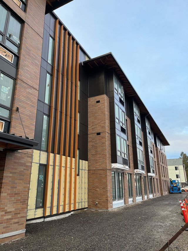A large building with a lot of windows is under construction.