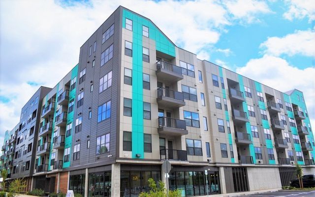 A large apartment building with a lot of windows and balconies.