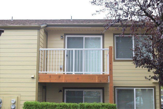 A house with a balcony and sliding glass doors