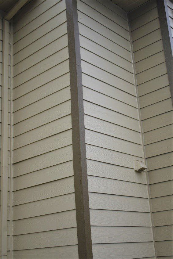 A close up of the side of a house with siding