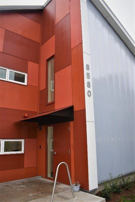 A red and white building with a staircase leading up to the door